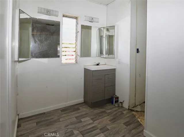 a bathroom with a granite countertop toilet sink and mirror