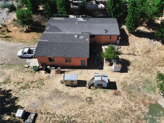 an aerial view of a house with a yard covered with snow in front of house