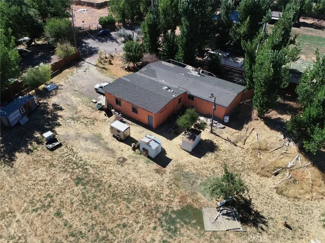 an aerial view of a house with yard and parking