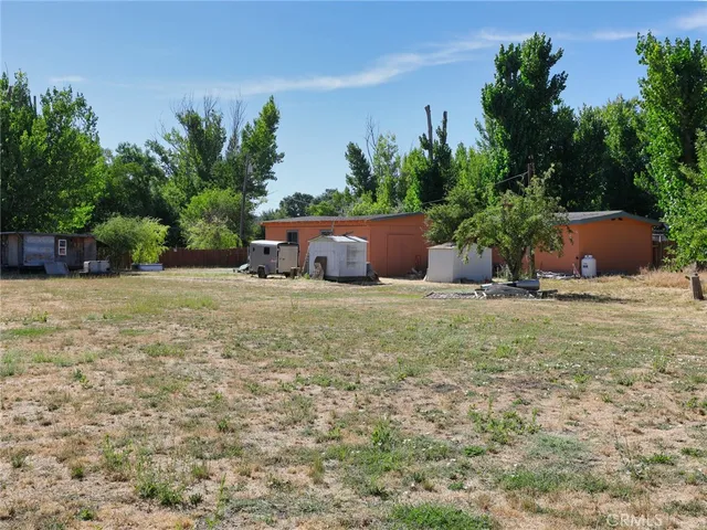 a view of a house with yard and sitting area
