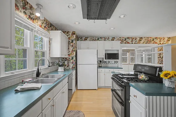 a kitchen with stainless steel appliances a sink stove and refrigerator