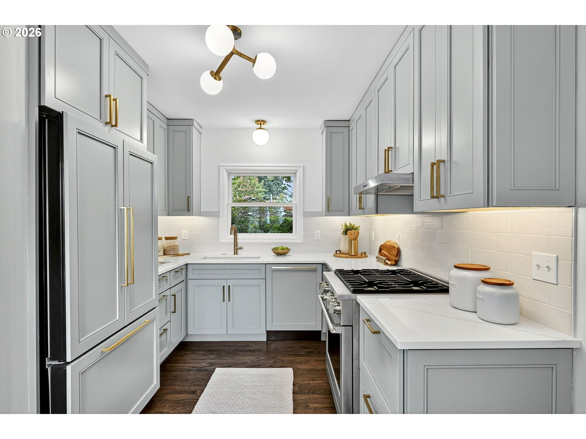 8035 Southwest 8th Avenue Portland, OR 97219 - Photo 15 of 42 a kitchen with a sink a refrigerator and cabinets