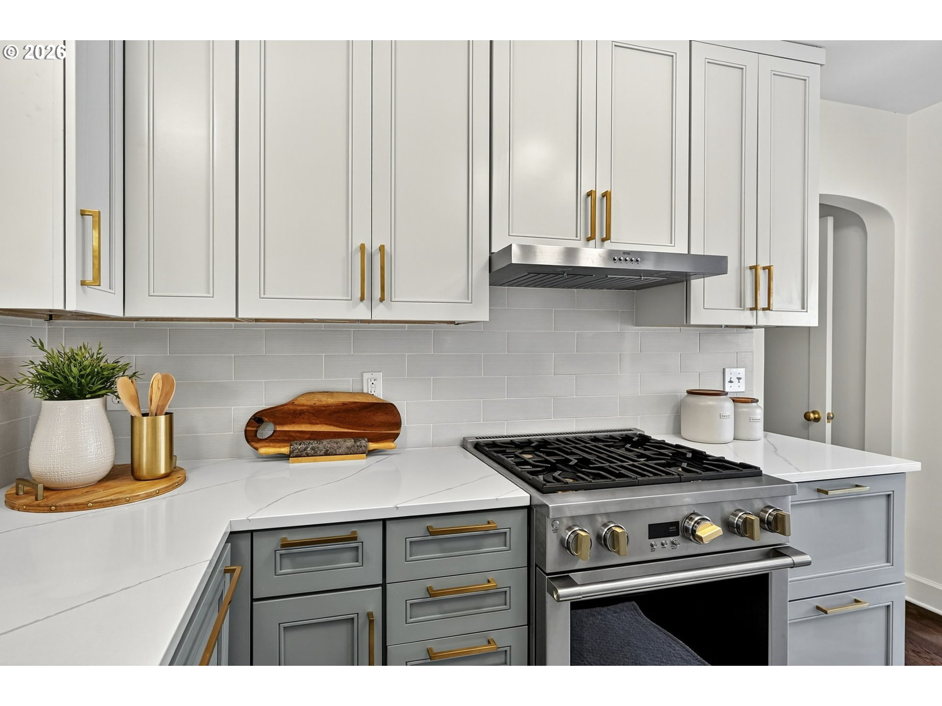 8035 Southwest 8th Avenue Portland, OR 97219 - Photo 17 of 42 a kitchen with granite countertop a stove a sink and a white cabinets