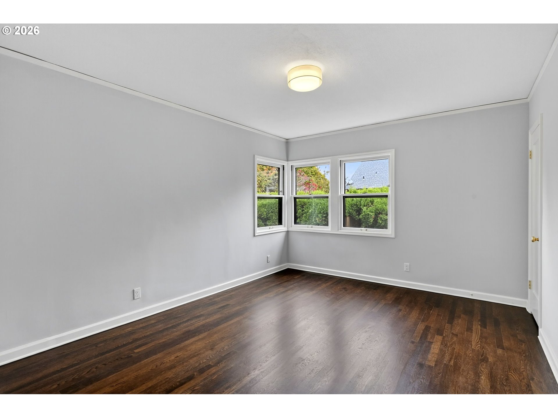 8035 Southwest 8th Avenue Portland, OR 97219 - Photo 18 of 42 a view of an empty room with wooden floor and a window