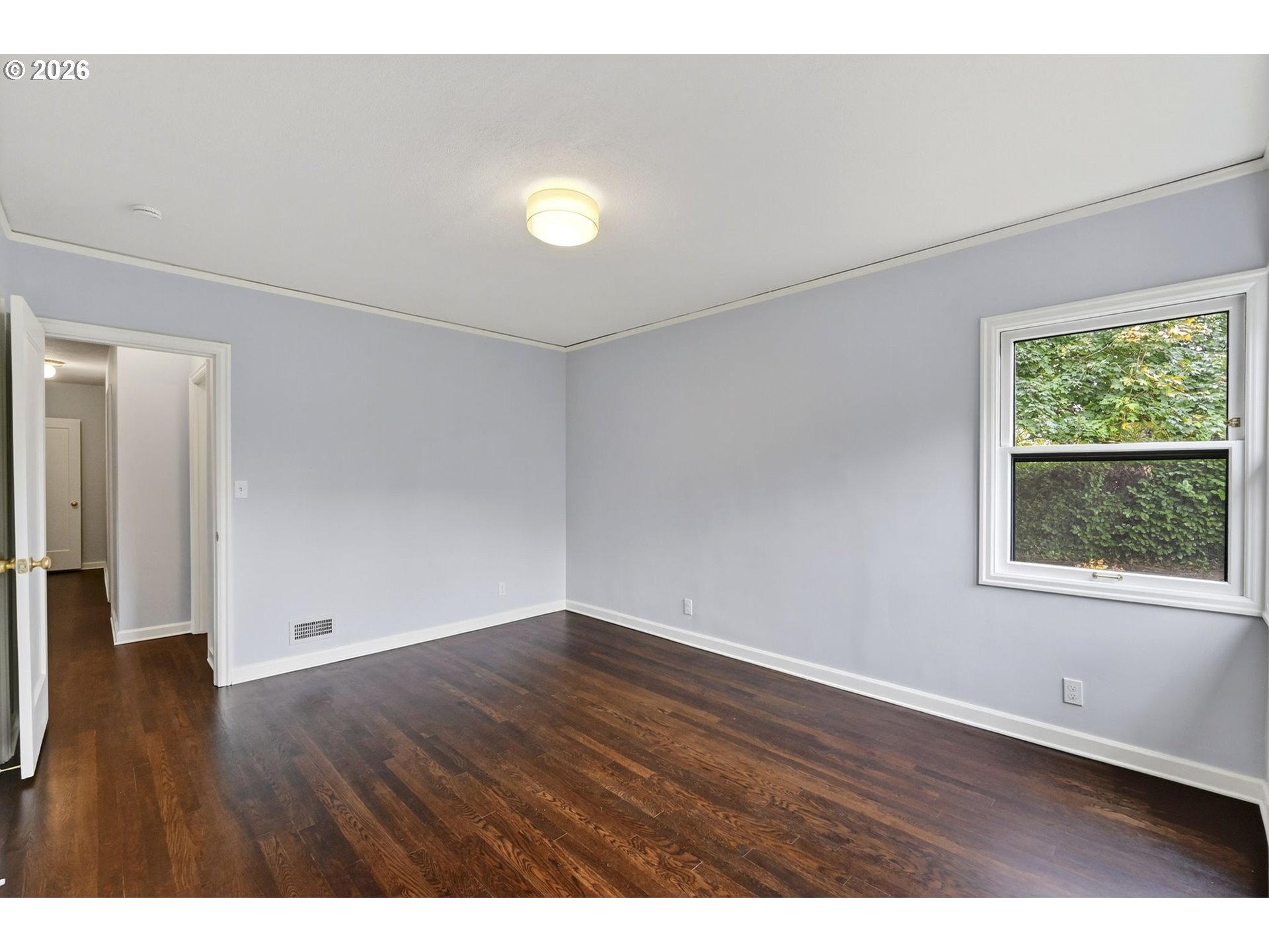 8035 Southwest 8th Avenue Portland, OR 97219 - Photo 19 of 42 an empty room with wooden floor and windows