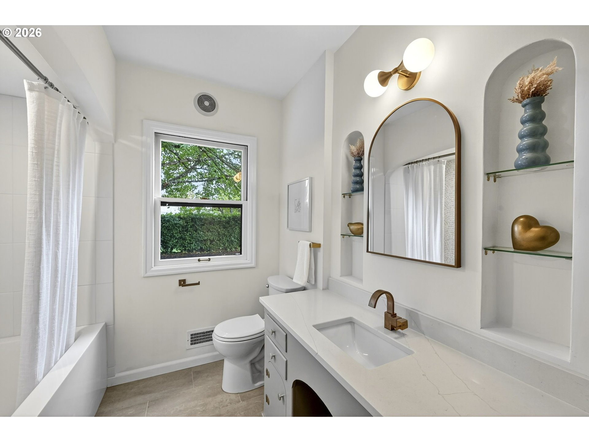 8035 Southwest 8th Avenue Portland, OR 97219 - Photo 20 of 42 a bathroom with a granite countertop sink a toilet and a mirror