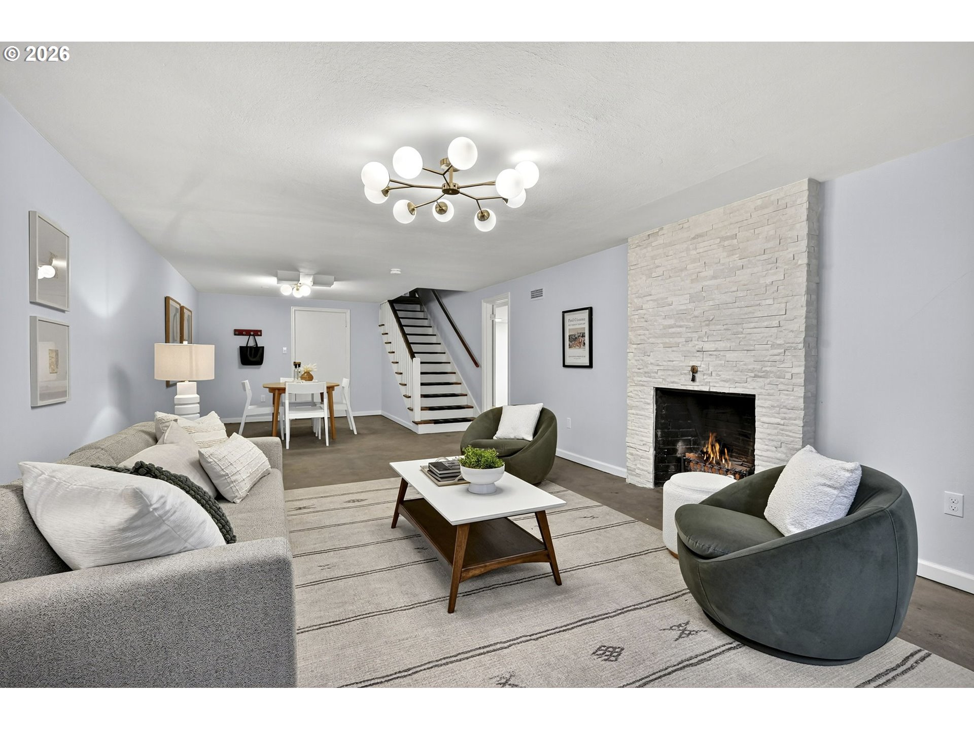 8035 Southwest 8th Avenue Portland, OR 97219 - Photo 31 of 42 a living room with furniture a fireplace and a flat screen tv