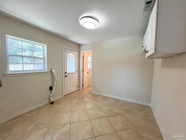 an empty room with windows and closet
