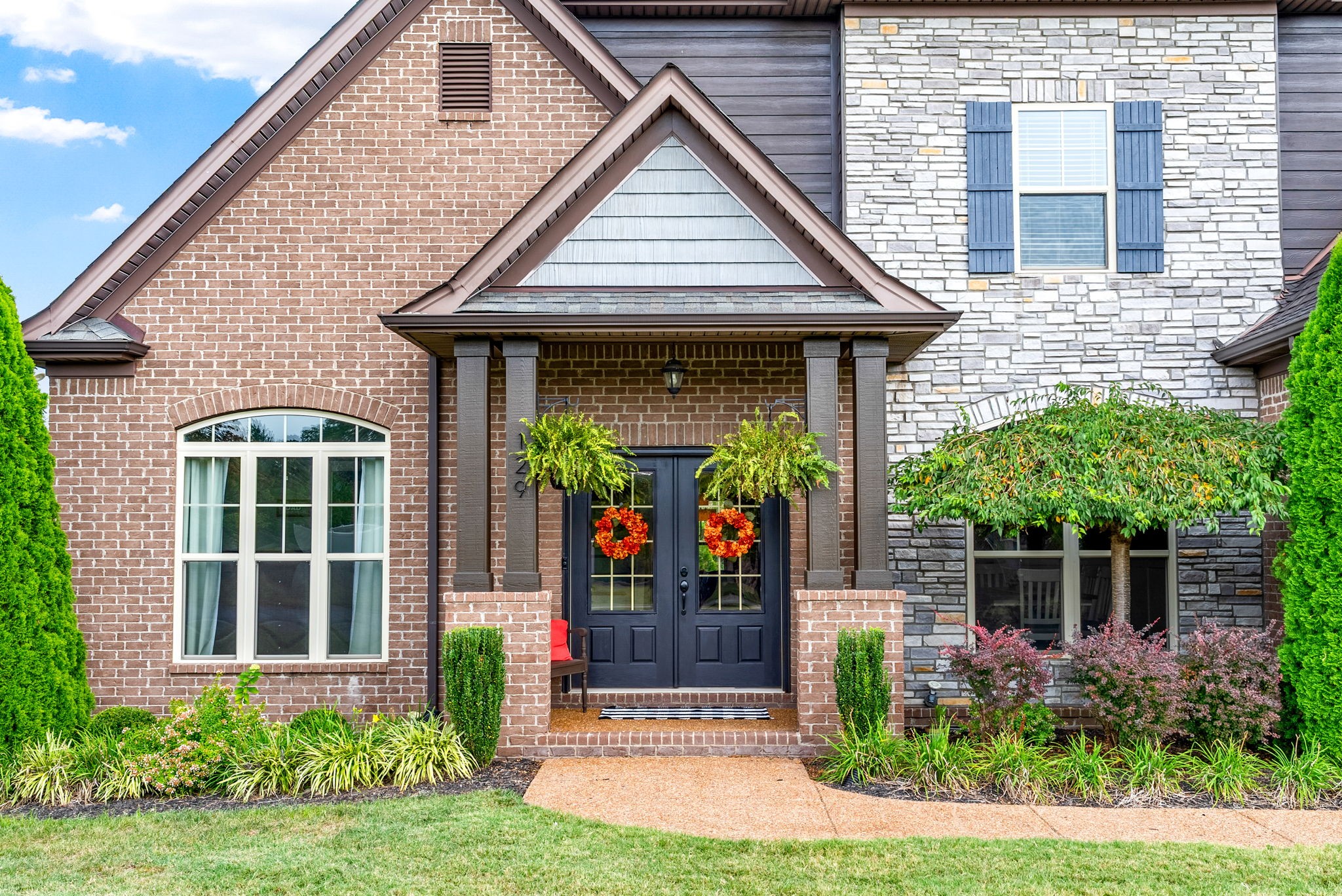 129 Springfield Drive Lebanon, TN 37087 - Photo 4 of 47 a view of a house with potted plants and a yard