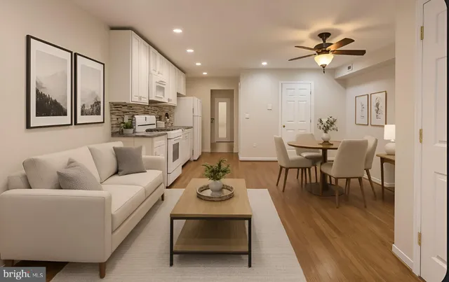 a living room with furniture kitchen and a chandelier