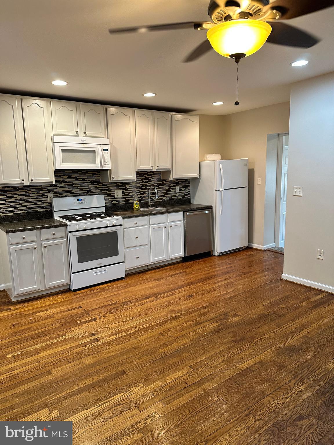 1913 Rosedale Street Northeast, Unit 1 Washington, DC 20002 - Photo 15 of 31 a kitchen with stainless steel appliances a stove a refrigerator sink and microwave