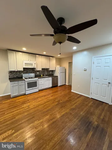 a view of a kitchen with a stove cabinets and wooden floor