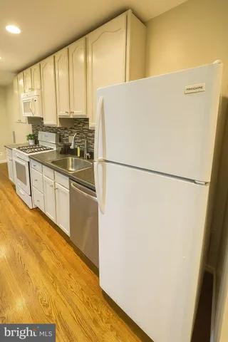 a white refrigerator freezer sitting in a kitchen