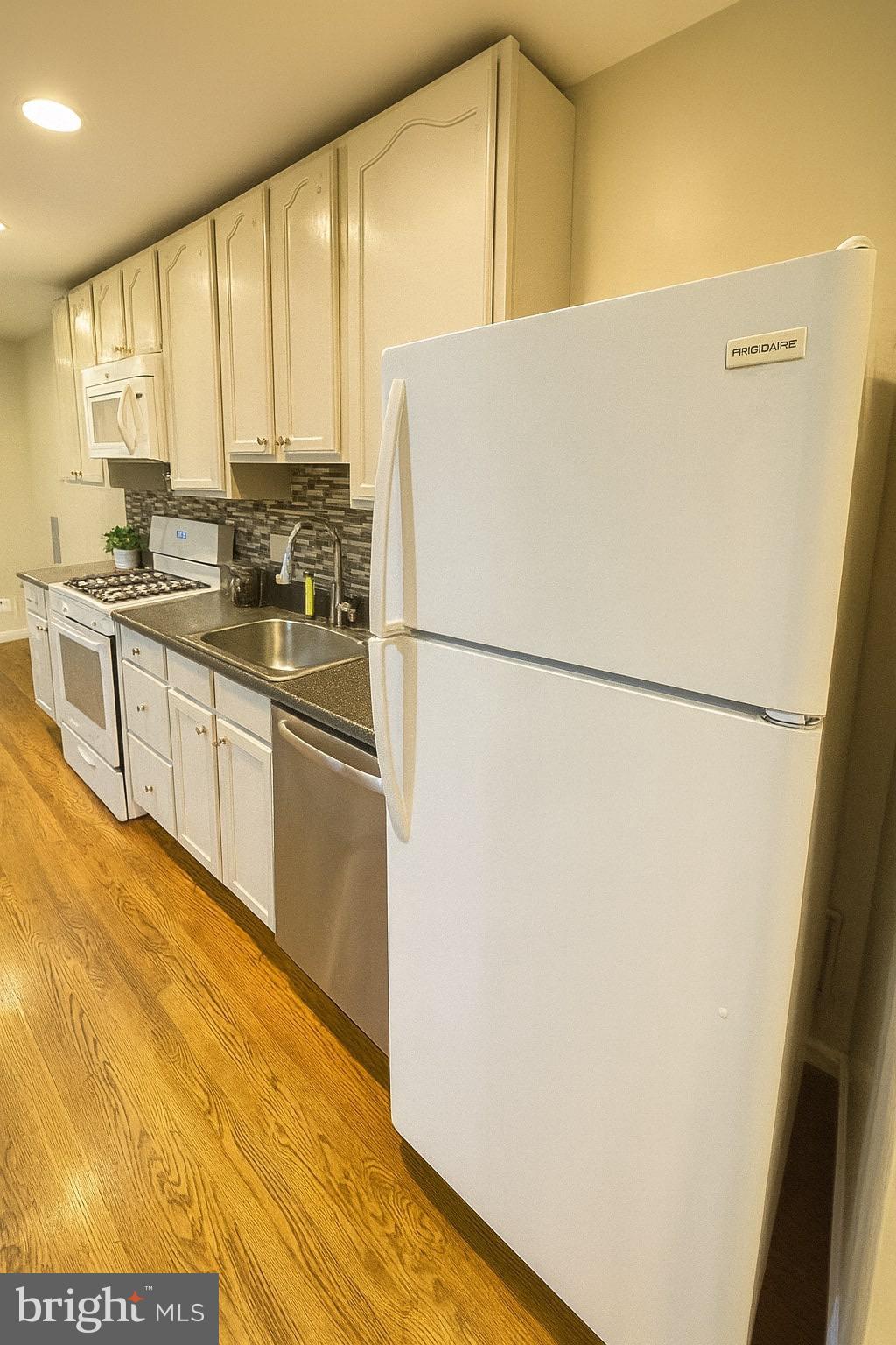 1913 Rosedale Street Northeast, Unit 1 Washington, DC 20002 - Photo 2 of 31 a white refrigerator freezer sitting in a kitchen