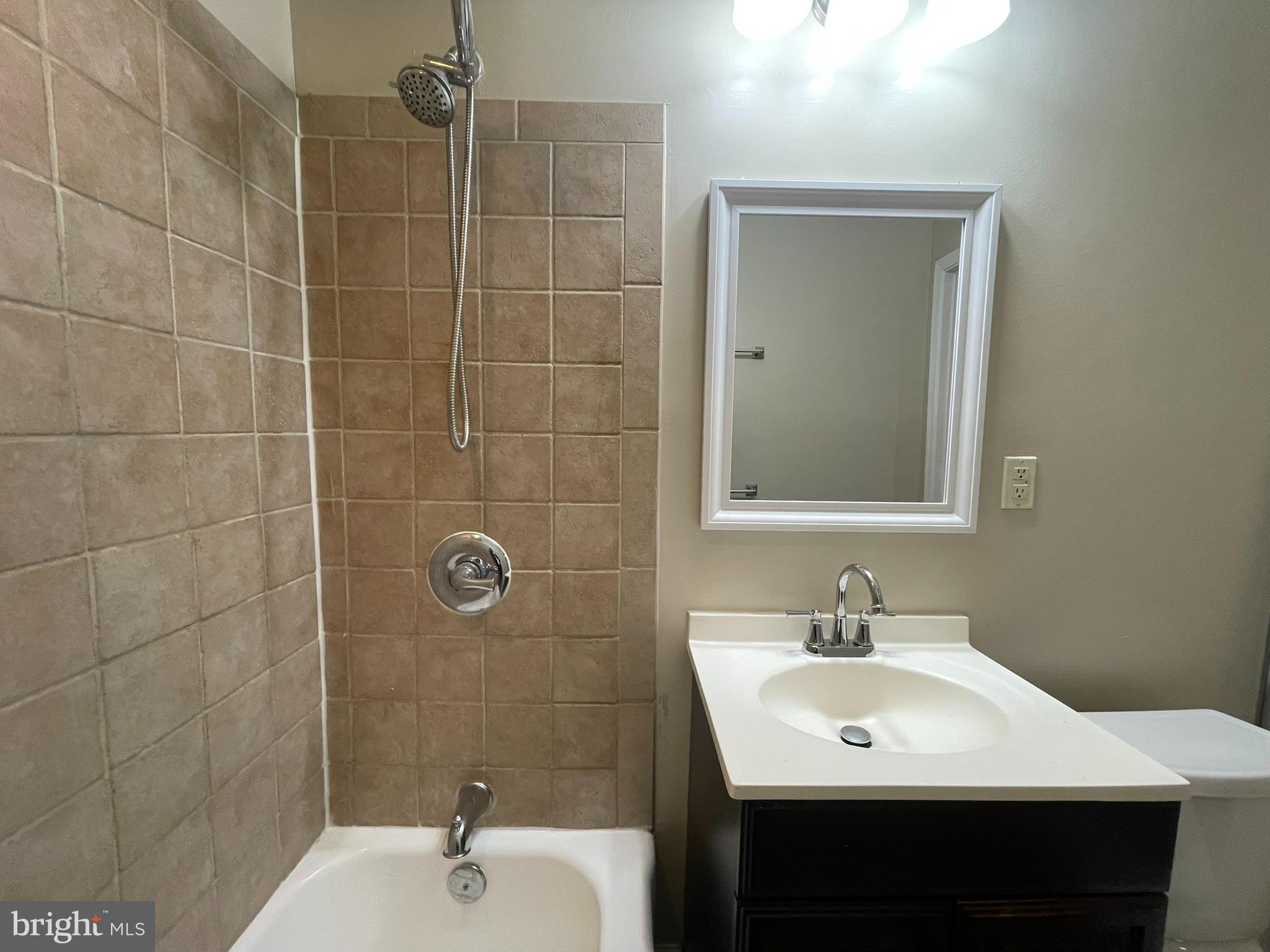 1913 Rosedale Street Northeast, Unit 1 Washington, DC 20002 - Photo 25 of 31 a bathroom with a sink shower and a mirror