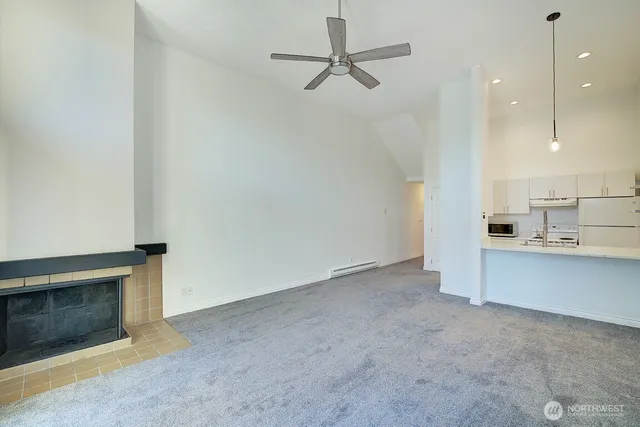 a view of a kitchen with a sink and a fireplace