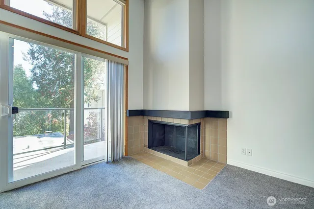 a living room with window and a fireplace