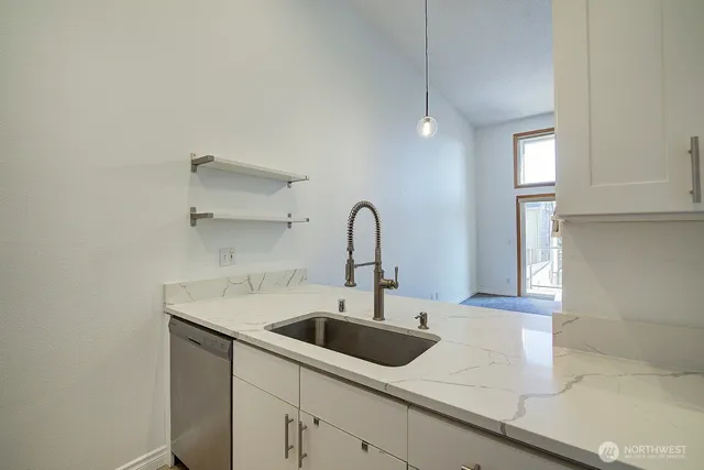 a kitchen with a sink and cabinets
