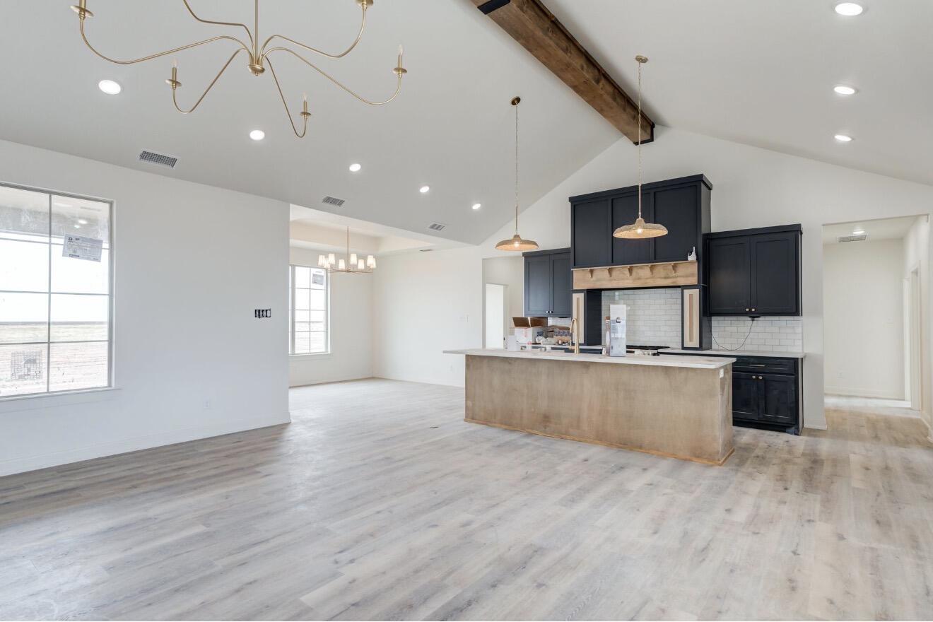 2003 County Road 7820 Lubbock, TX 79423 - Photo 2 of 10 a large kitchen with stainless steel appliances kitchen island a large counter top and a wooden floor