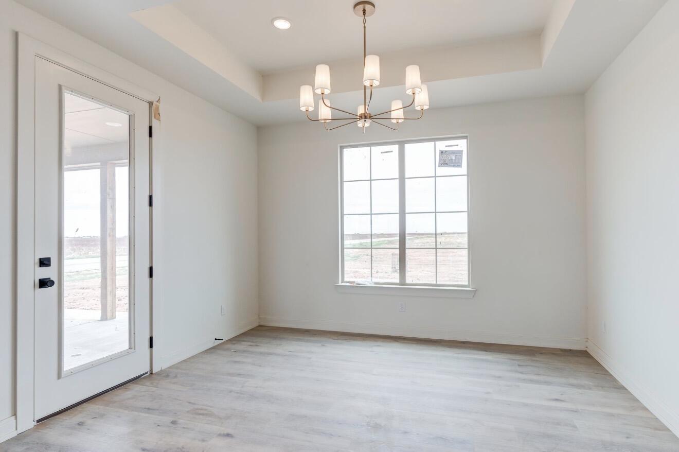 2003 County Road 7820 Lubbock, TX 79423 - Photo 5 of 10 an empty room with chandelier and windows