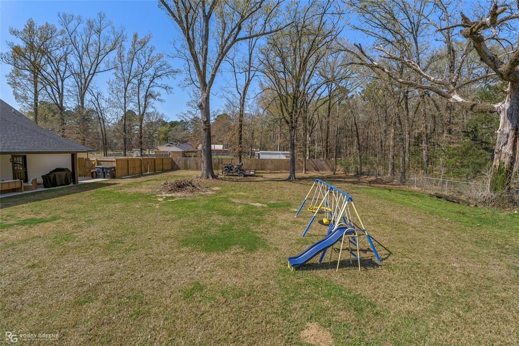 396 Collinswood Road Stonewall, LA 71078 - Photo 6 of 32 a view of a backyard with a tree