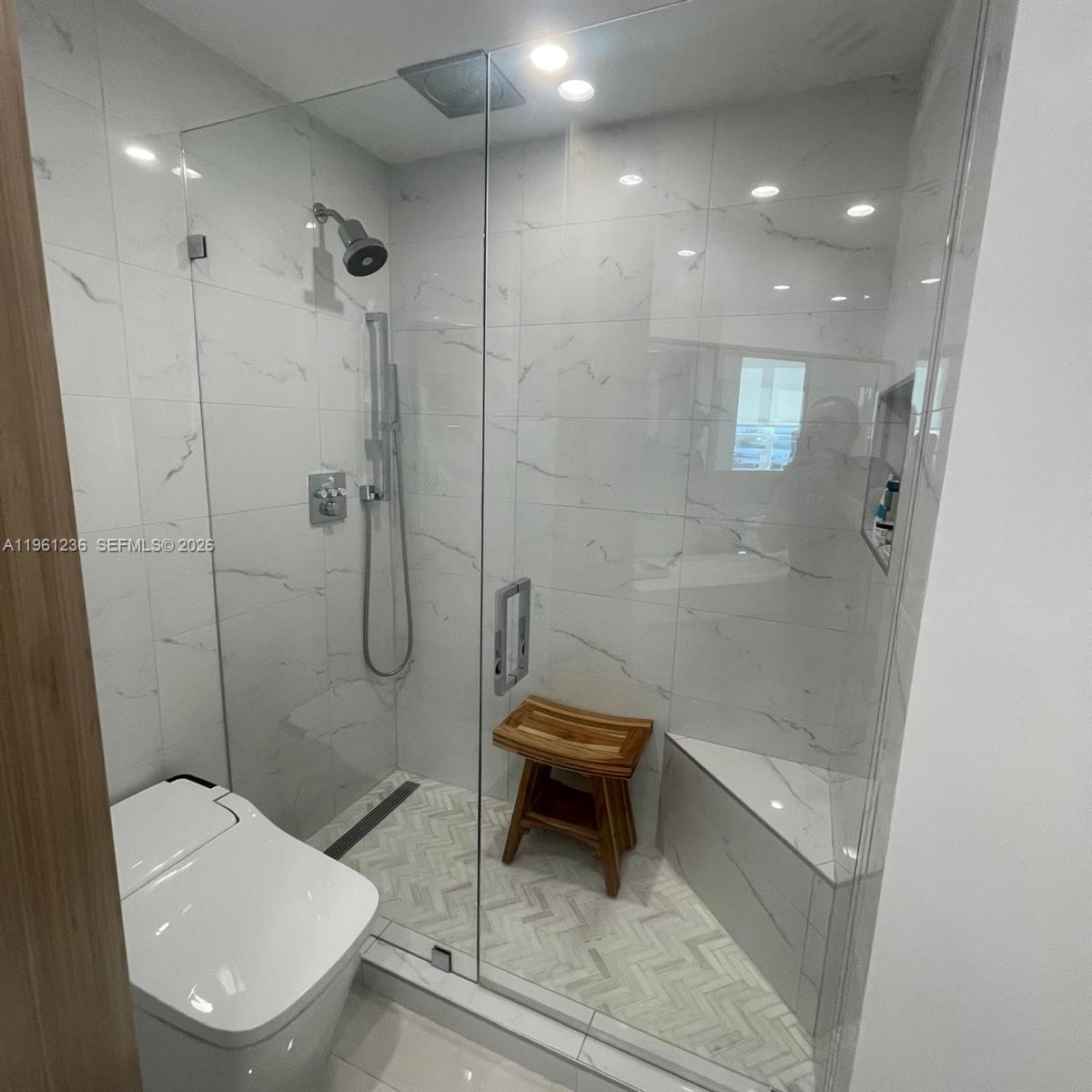 888 Brickell Key Drive, Unit 802 Miami, FL 33131 - Photo 11 of 16 a bathroom with a toilet and a shower