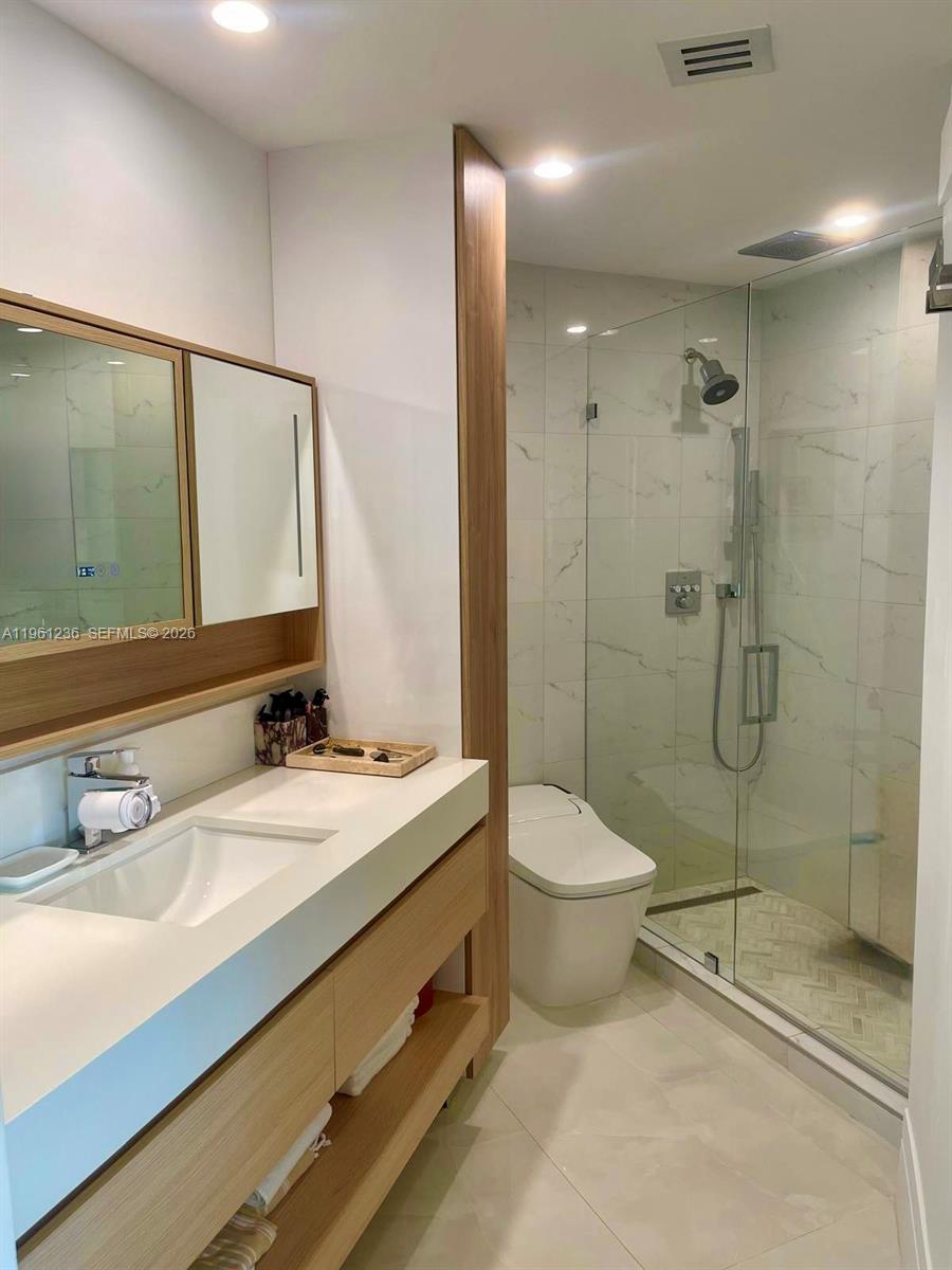 888 Brickell Key Drive, Unit 802 Miami, FL 33131 - Photo 14 of 16 a bathroom with a sink toilet and shower