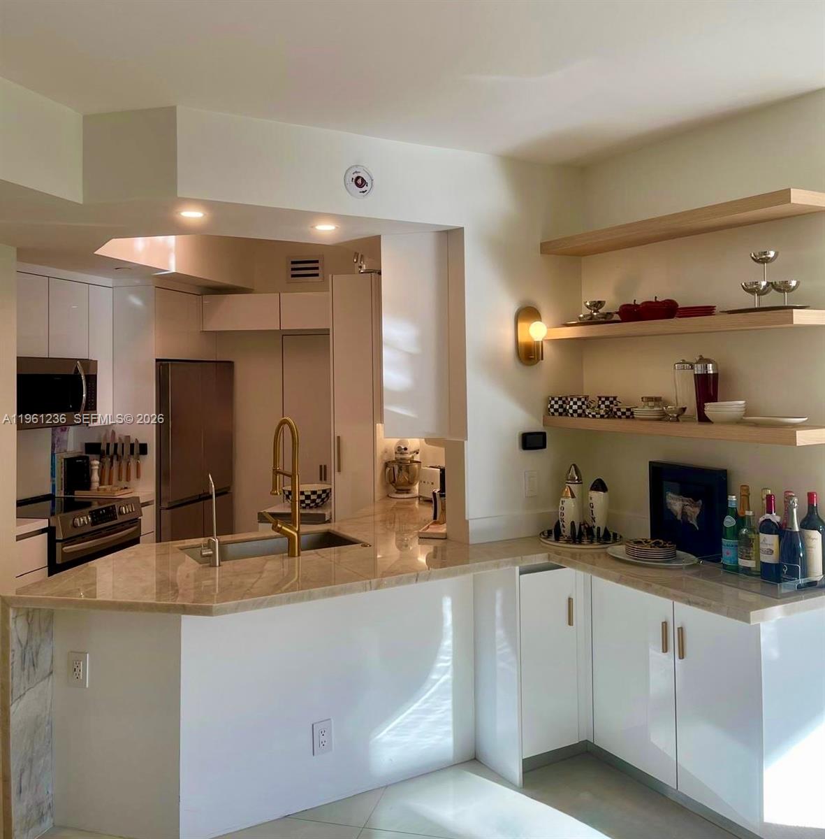 888 Brickell Key Drive, Unit 802 Miami, FL 33131 - Photo 4 of 16 a kitchen with counter top space cabinets and appliances