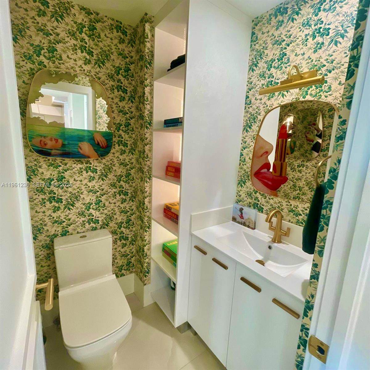 888 Brickell Key Drive, Unit 802 Miami, FL 33131 - Photo 5 of 16 a bathroom with a toilet sink and mirror