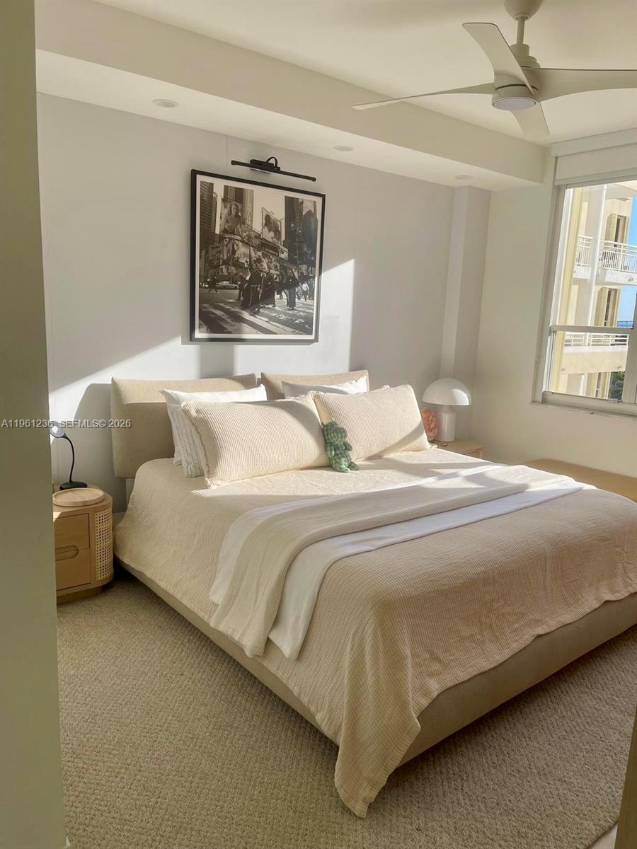 888 Brickell Key Drive, Unit 802 Miami, FL 33131 - Photo 6 of 16 a bedroom with a bed and wooden floor