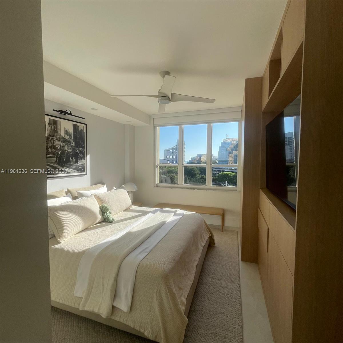 888 Brickell Key Drive, Unit 802 Miami, FL 33131 - Photo 8 of 16 a bedroom with a large bed and a window