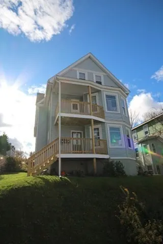 a front view of a house with a garden