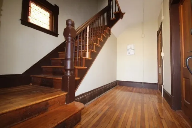 a view of entryway and hall with wooden floor