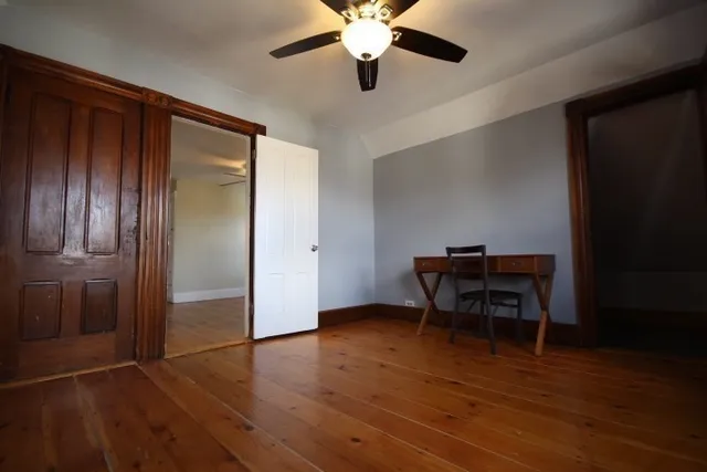 a view of a workspace with furniture and wooden floor