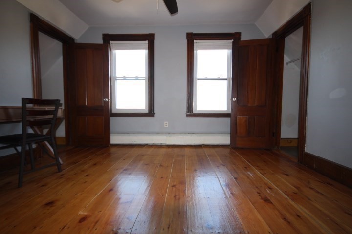 74 Green Hill Parkway Worcester, MA 01605 - Photo 20 of 42 an empty room with wooden floor and windows