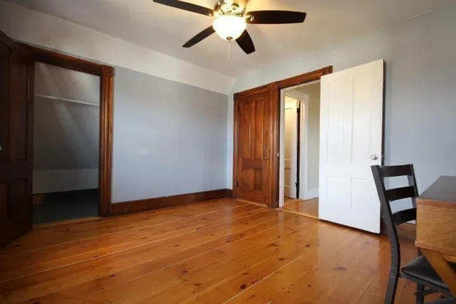 wooden floor in an empty room with a window