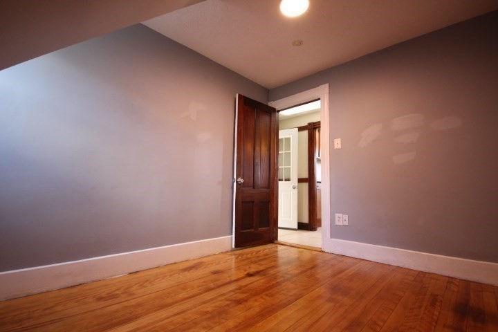 74 Green Hill Parkway Worcester, MA 01605 - Photo 22 of 42 an empty room with wooden floor and entrance