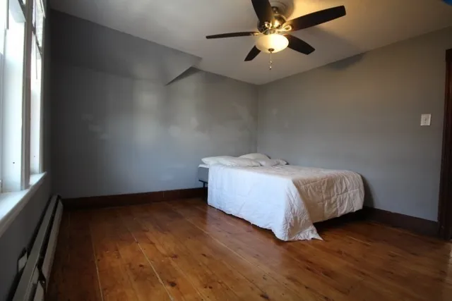a bed sitting in a room next to a window