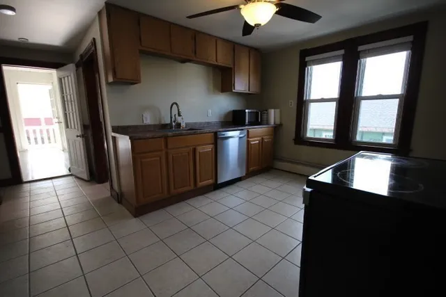a kitchen with stainless steel appliances a sink stove and cabinets