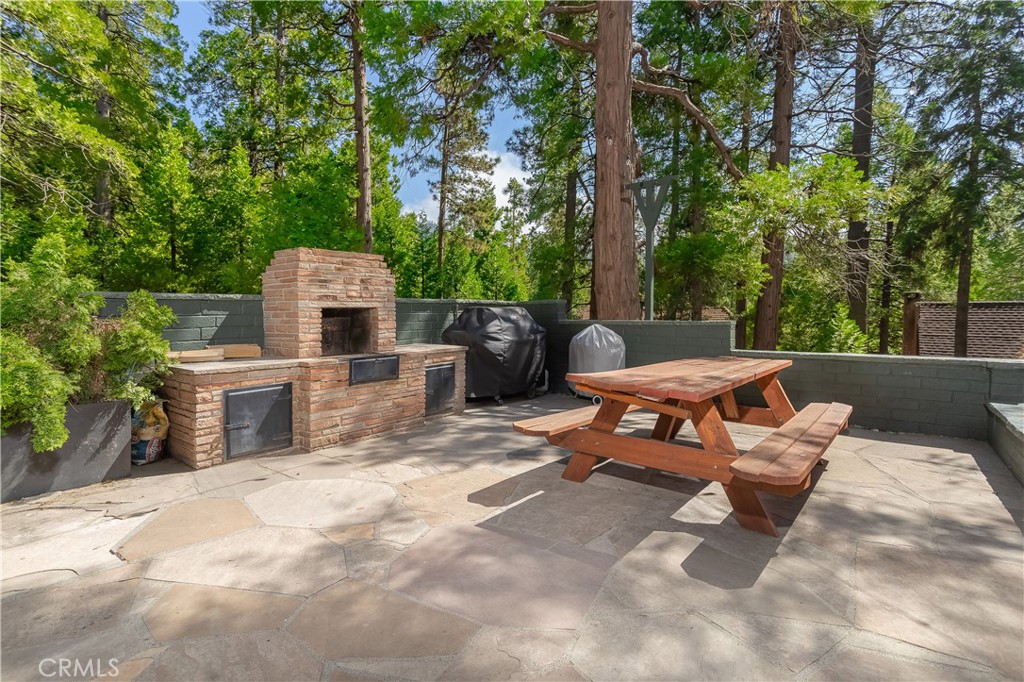 148 Bret Harte Road Lake Arrowhead, CA 92352 - Photo 11 of 23 a backyard of a house with fire pit and outdoor seating