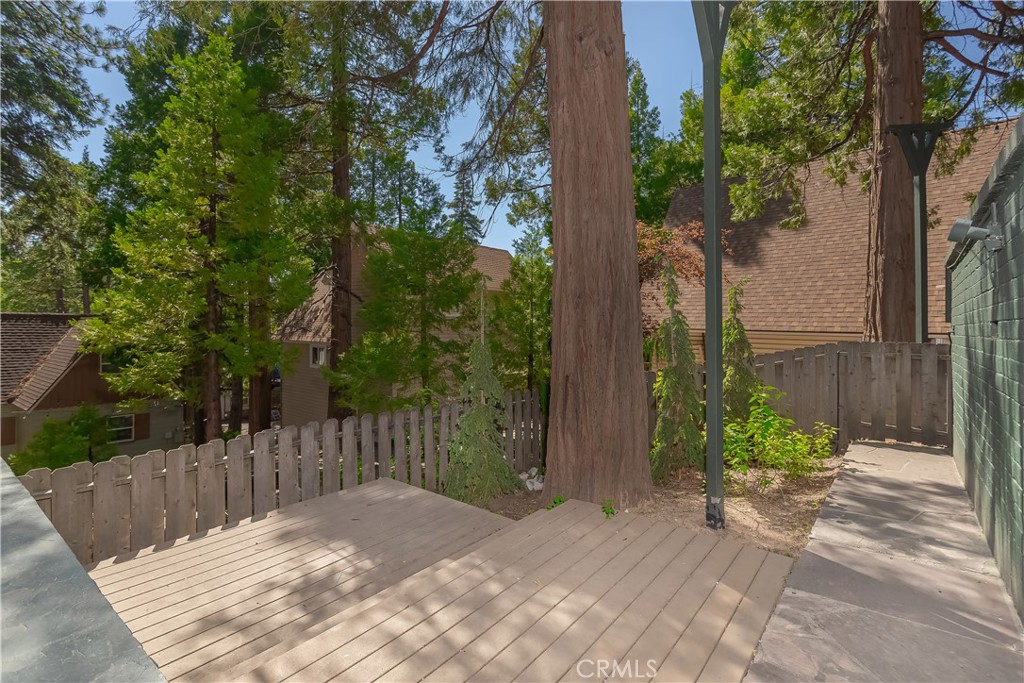 148 Bret Harte Road Lake Arrowhead, CA 92352 - Photo 12 of 23 a wooden bench sitting in front of a building