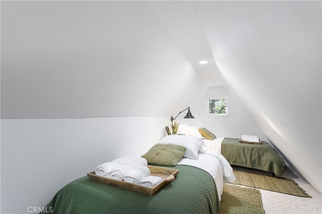 148 Bret Harte Road Lake Arrowhead, CA 92352 - Photo 15 of 23 a bedroom with a bed and window