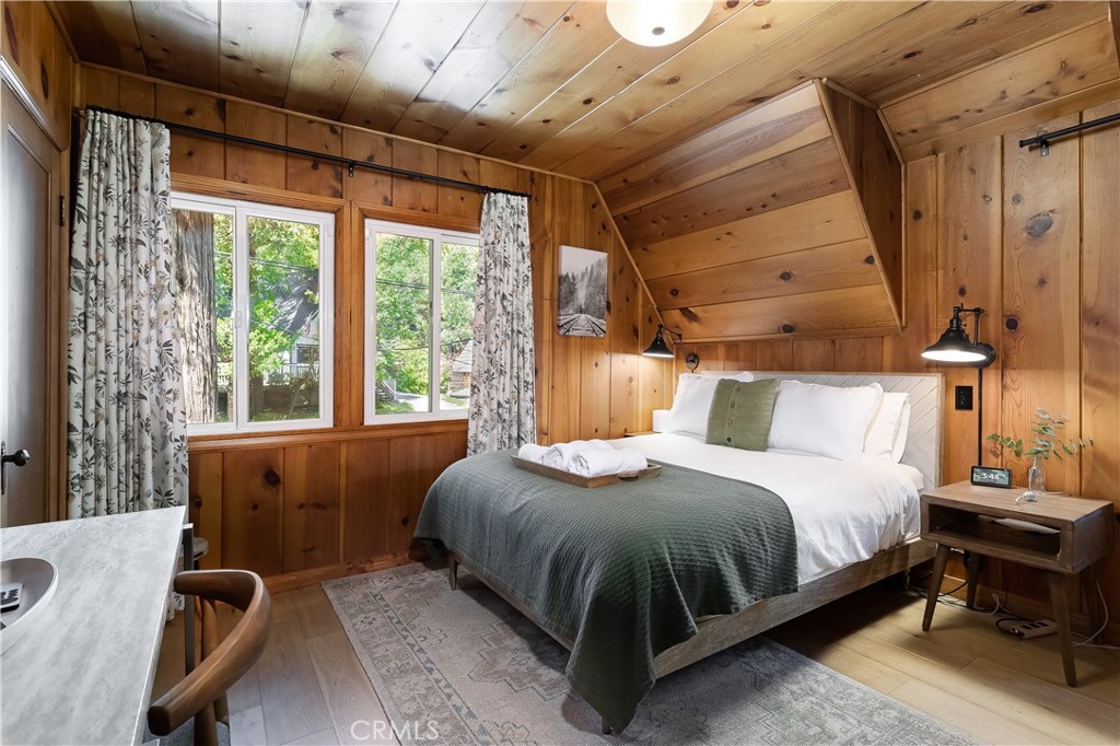148 Bret Harte Road Lake Arrowhead, CA 92352 - Photo 17 of 23 a bedroom with a bed and wooden floor