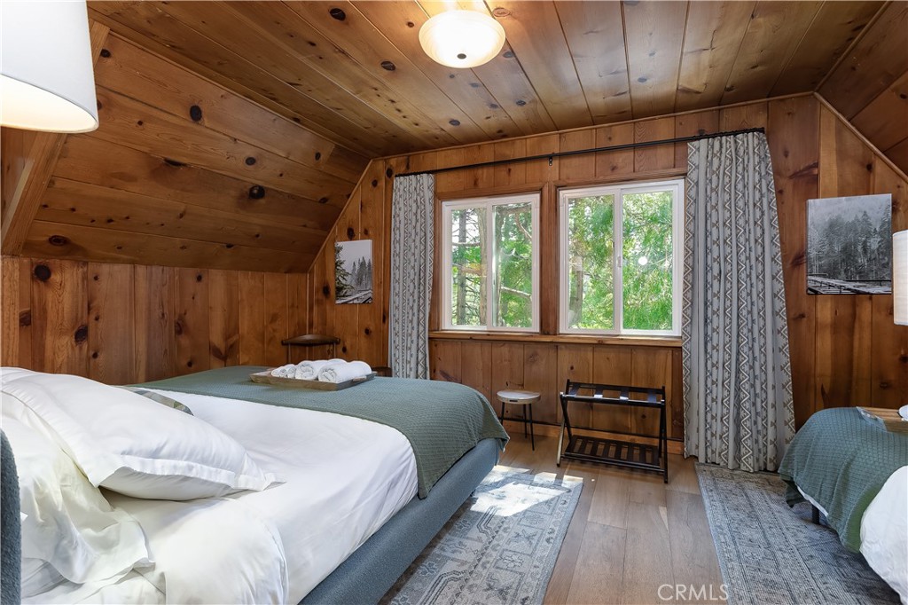 148 Bret Harte Road Lake Arrowhead, CA 92352 - Photo 19 of 23 a bedroom with furniture and a large window