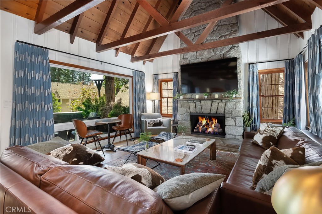 148 Bret Harte Road Lake Arrowhead, CA 92352 - Photo 3 of 23 a living room with furniture fireplace and a large window