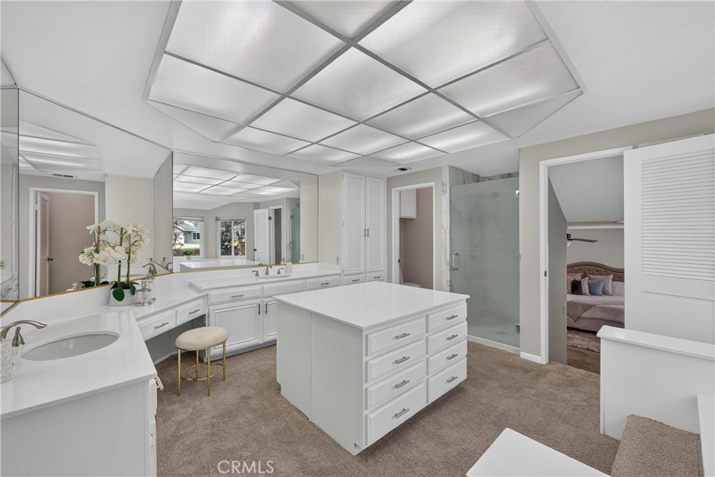 2935 Bluebell Avenue Brea, CA 92821 - Photo 22 of 38 Primary bathroom includes a walk-in shower, dual sinks, dedicated vanity space, and a spacious walk-in closet, creating a comfortable private retreat
