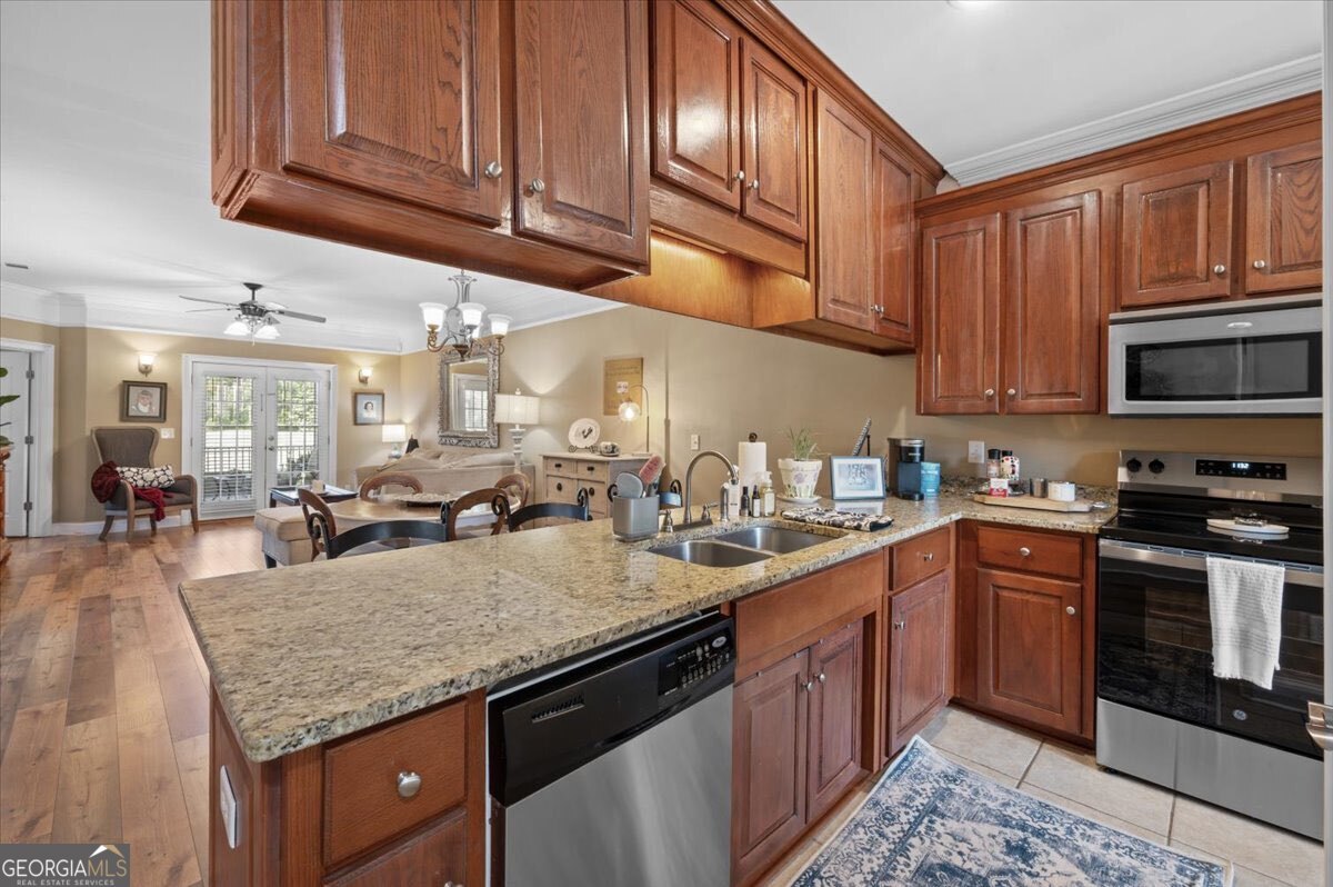 7272 Shellman Bluff Road Northeast, Unit 21 Townsend, GA 31331 - Photo 12 of 34 a kitchen with stainless steel appliances granite countertop a stove sink microwave and cabinets