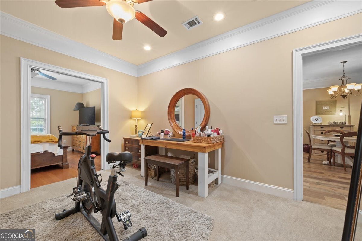 7272 Shellman Bluff Road Northeast, Unit 21 Townsend, GA 31331 - Photo 19 of 34 a view of a room with furniture and a ceiling fan
