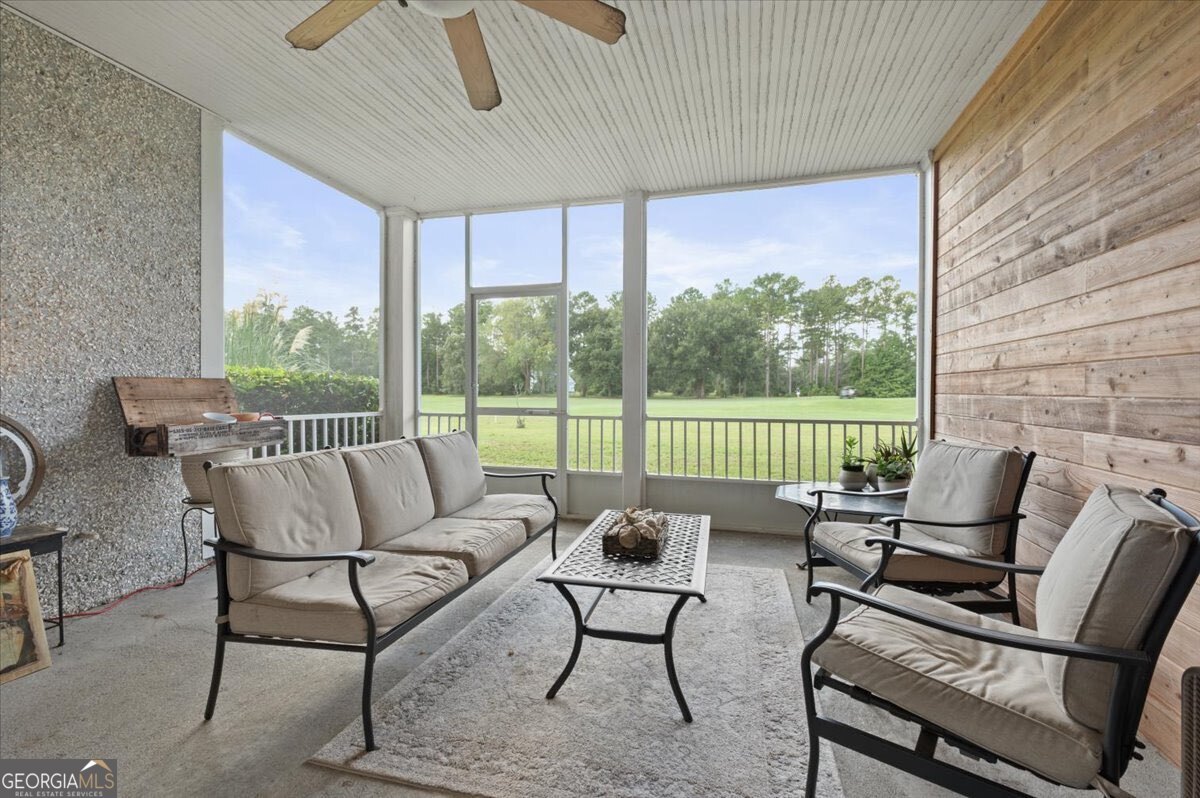 7272 Shellman Bluff Road Northeast, Unit 21 Townsend, GA 31331 - Photo 25 of 34 a roof deck with a couch and chairs