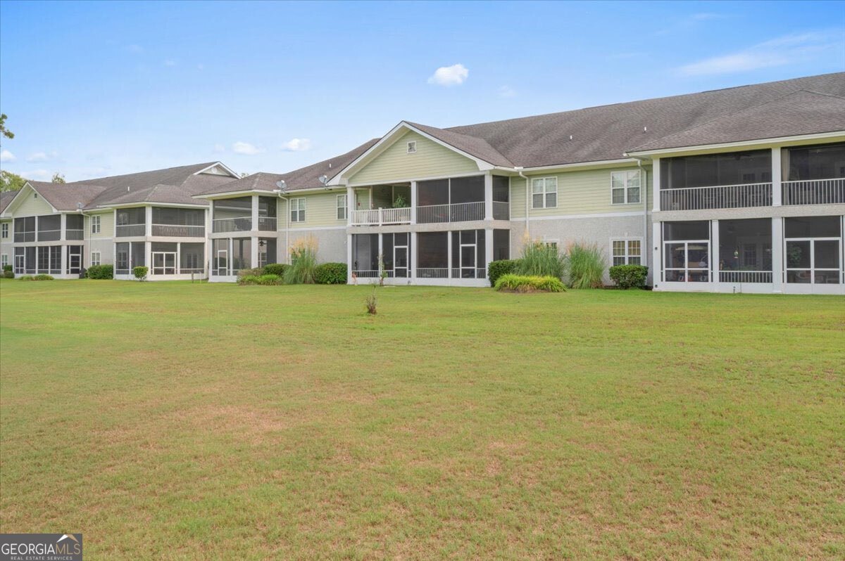 7272 Shellman Bluff Road Northeast, Unit 21 Townsend, GA 31331 - Photo 27 of 34 a front view of a building with a garden